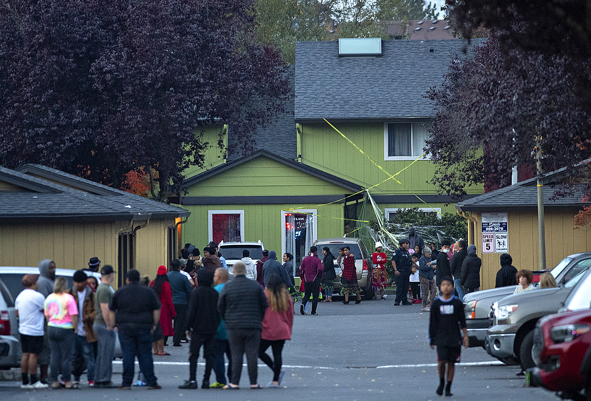People gather at Alder Creek Apartments and Townhomes after a shooting in northeast Vancouver on Tuesday evening, Oct. 19, 2021. The apartment complex is just west of the location where Clark County sheriffs deputies fatally shot a suspect in an assault on Sunday.