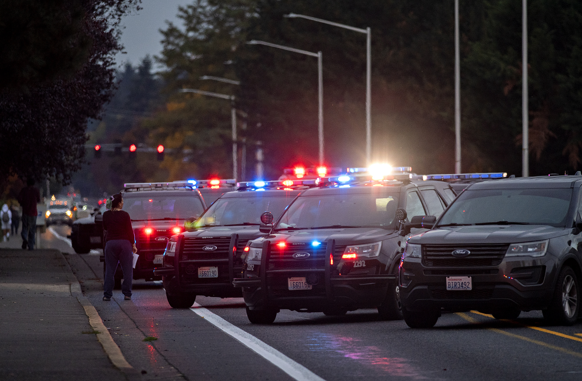 Multiple vehicles belonging to law enforcement close the road at Northeast 49th Street near Alder Creek Apartments and Townhomes in northeast Vancouver on Tuesday evening, Oct. 19, 2021.