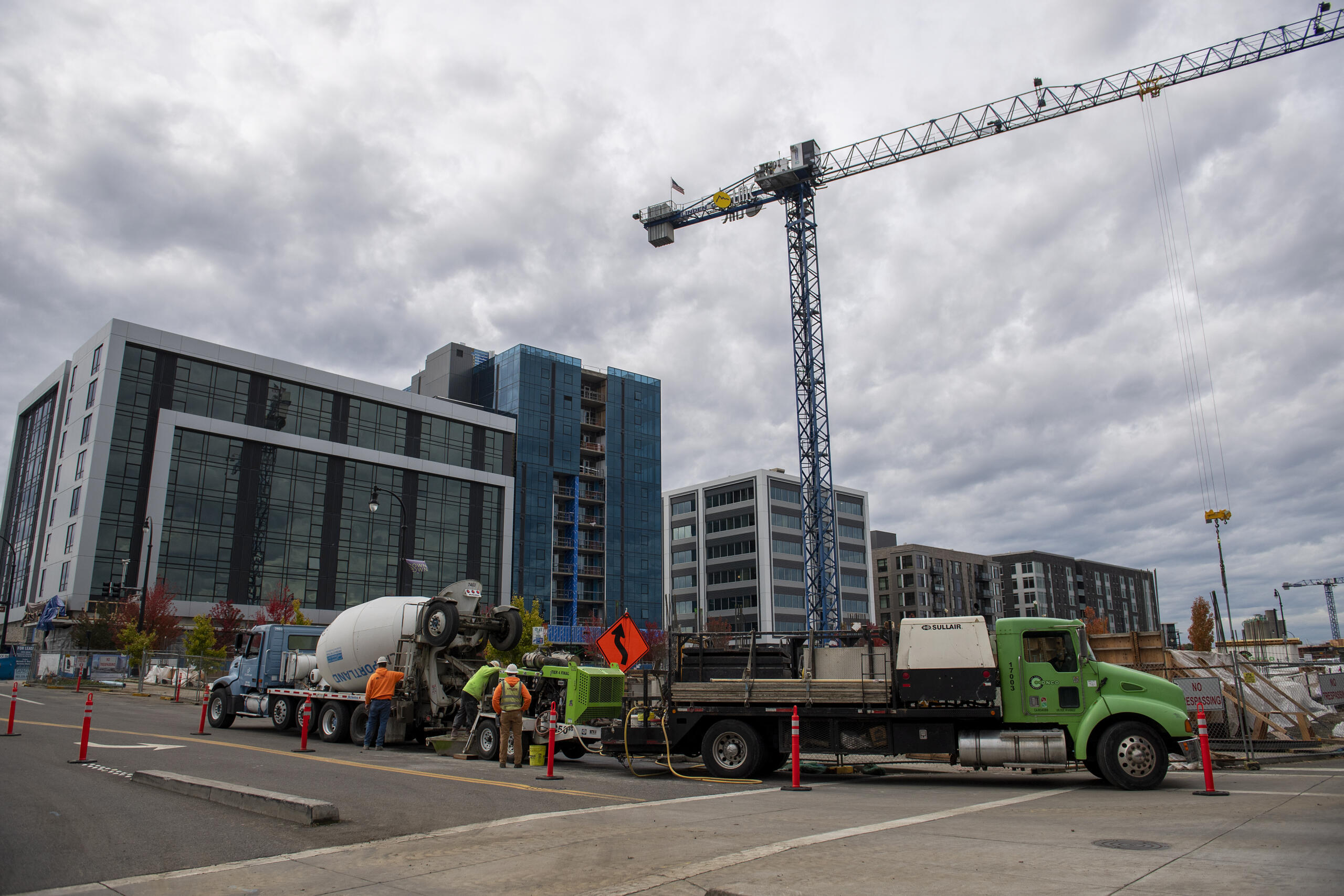 Workers help construct the future parking garage at the corner of Columbia Way and Esther Street in The Waterfront Vancouver on Thursday afternoon, Oct. 21, 2021.