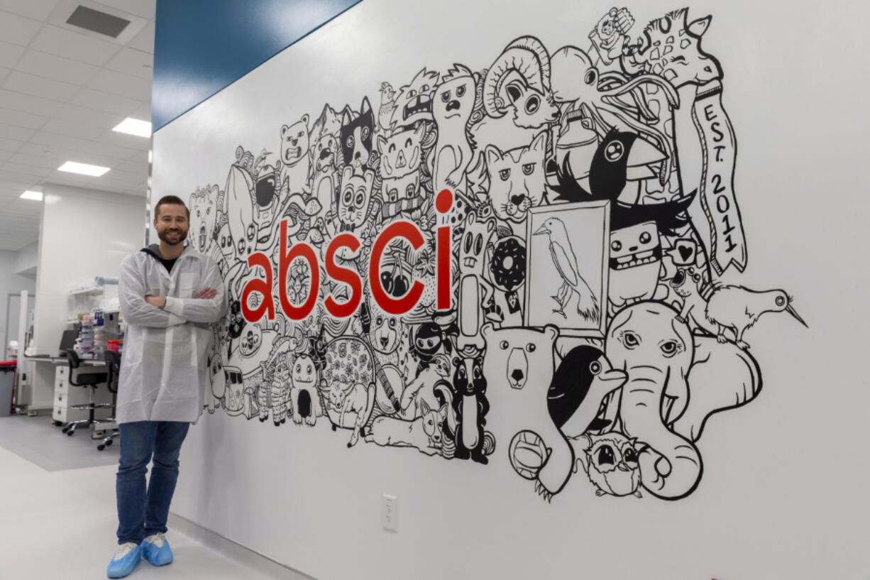 Founder and CEO Sean McClain poses next to a mural in a lab at Absci Corp., headquartered in Vancouver, during a tour on Monday. The drug-discovery company, founded in Portland in 2011, moved to Vancouver in 2016. (Randy L.