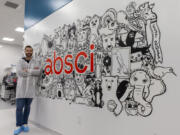 Founder and CEO Sean McClain poses next to a mural in a lab at Absci Corp., headquartered in Vancouver, during a tour on Monday. The drug-discovery company, founded in Portland in 2011, moved to Vancouver in 2016. (Randy L.