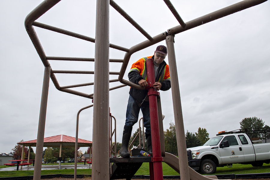 Don Wingate of the city of Washougal repairs an aging play structure at Hamllik Park in Washougal on Friday morning. Washougal city workers are wrapping up work on upgrades to the park, which will include replacing the play structure.