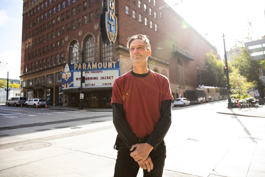 Christopher Smith is a stage hand working on setting up a show at the Paramount Theater in Seattle on Friday, Oct. 1, 2021. He is back to work as the pandemic lifts -- but the end of benefits isn't what made that happen.