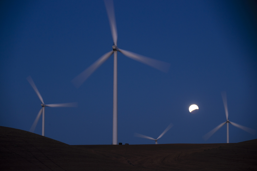 Turbines spin behind the towers on the Shiloh II wind farm in the Montezuma Hills near Bird's Landing, California, on May 26, 2021.