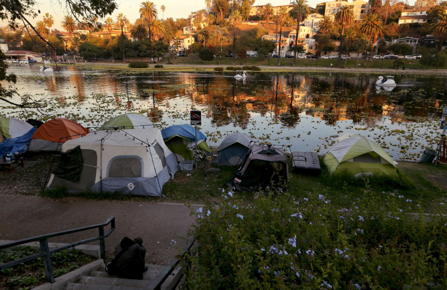 A homeless encampment on the banks of Echo Park Lake in Los Angeles, Dec. 30, 2020. Countless homeless people shelter in nooks and crannies in an urban landscape covered in graffiti and trash as the city struggles with reduced tax revenues and budgets.