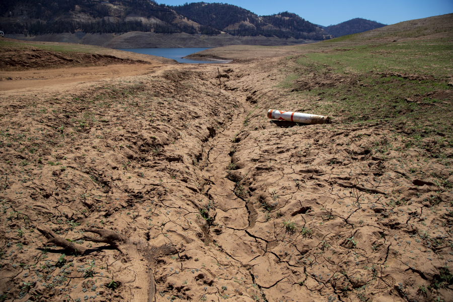 Dried mud and a stranded buoy on the lakebed at Lake Oroville, which stands at 33 percent full and 40 percent of historical average when this photograph was taken, on Tuesday, June 29, 2021 in Oroville, California.