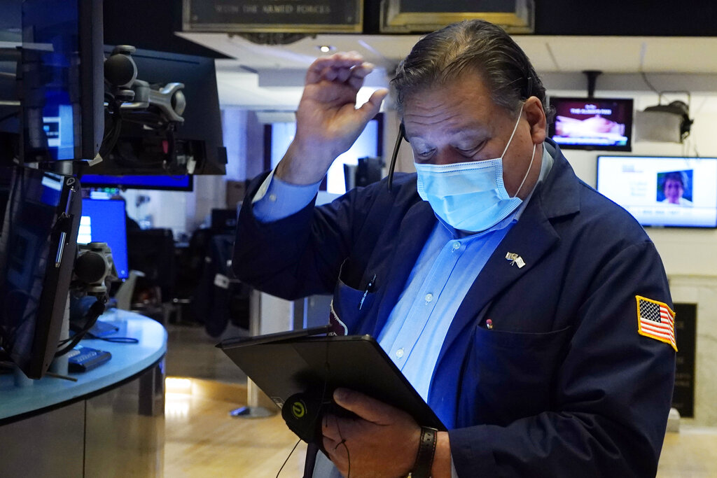 Trader John Santiago works on the floor of the New York Stock Exchange, Tuesday, Oct. 19, 2021. Stocks are moving modestly higher on Wall Street in early trading Tuesday as corporate earnings reporting gets into full swing.
