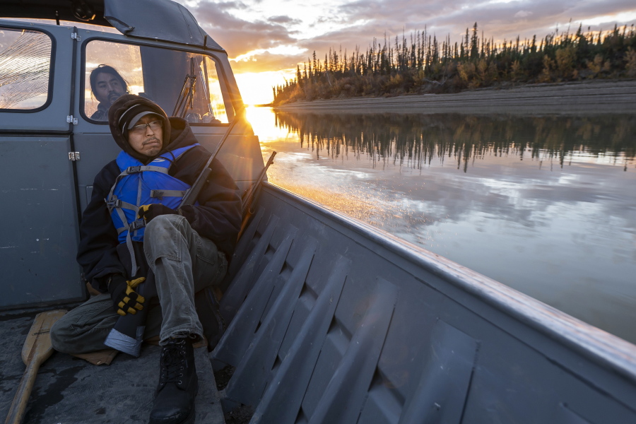 Michael Williams scans the shoreline for moose while traveling up the Yukon River on Tuesday, Sept. 14, 2021, near Stevens Village, Alaska. For the first time in memory, both king and chum salmon have dwindled to almost nothing and the state has banned salmon fishing on the Yukon. The remote communities that dot the river and live off its bounty are desperate and doubling down on moose and caribou hunts in the waning days of fall.
