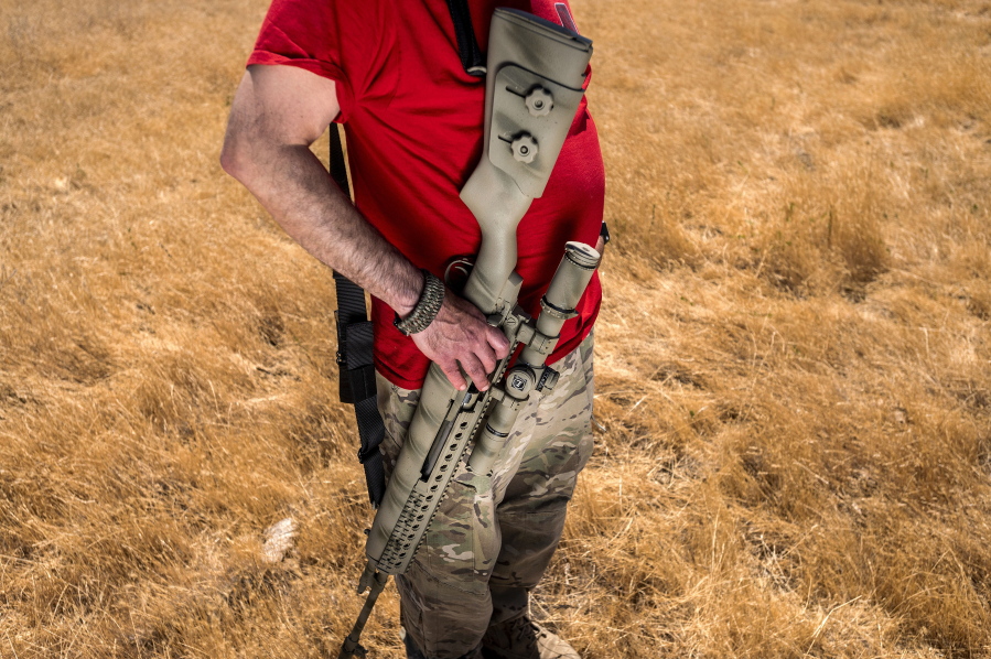 Firearms instructor Michael Palombo holds a Springfield Armory M25 rifle June 6 during field testing to measure radio frequency identification signal range in Hickman, Calif. Palombo inserted an RFID tag into the rifle for the test.