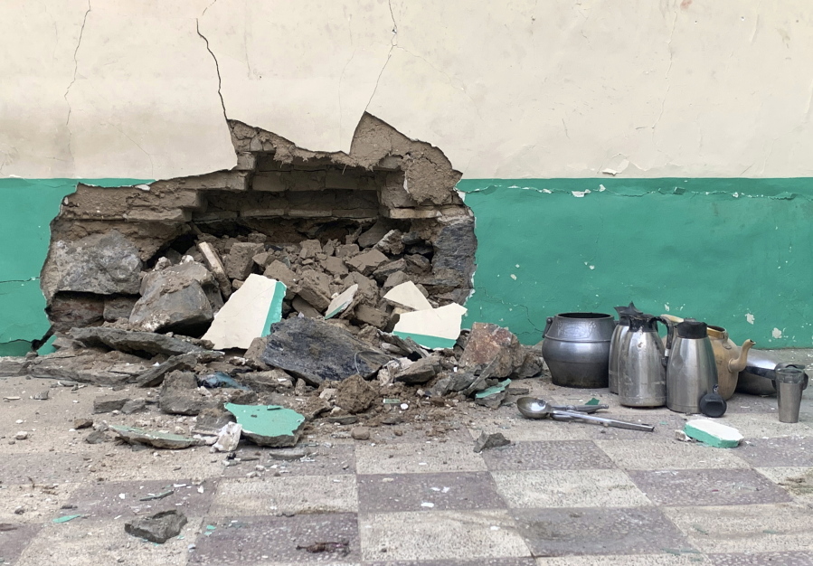 Damaged wall of a mosque is seen following a suicide bombers attack in the city of Kandahar, southwest Afghanistan, Friday, Oct. 15, 2021.  Suicide bombers attacked a Shiite mosque in southern Afghanistan that was packed with worshippers attending Friday prayers, killing several people and wounding others, according to a hospital official and a witness.