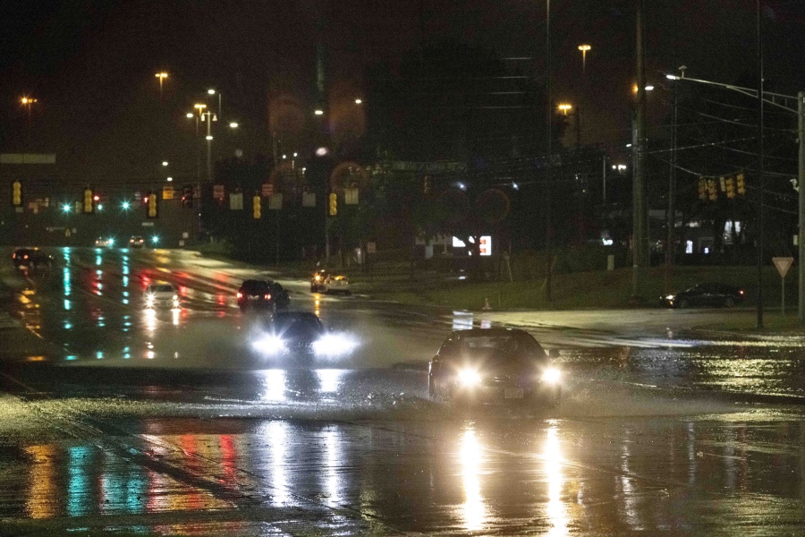 Car travel through floodwaters on Montgomery highway Wednesday, Oct. 6, 2021, near the Riverchase Galleria complex in Birmingham, Ala.
