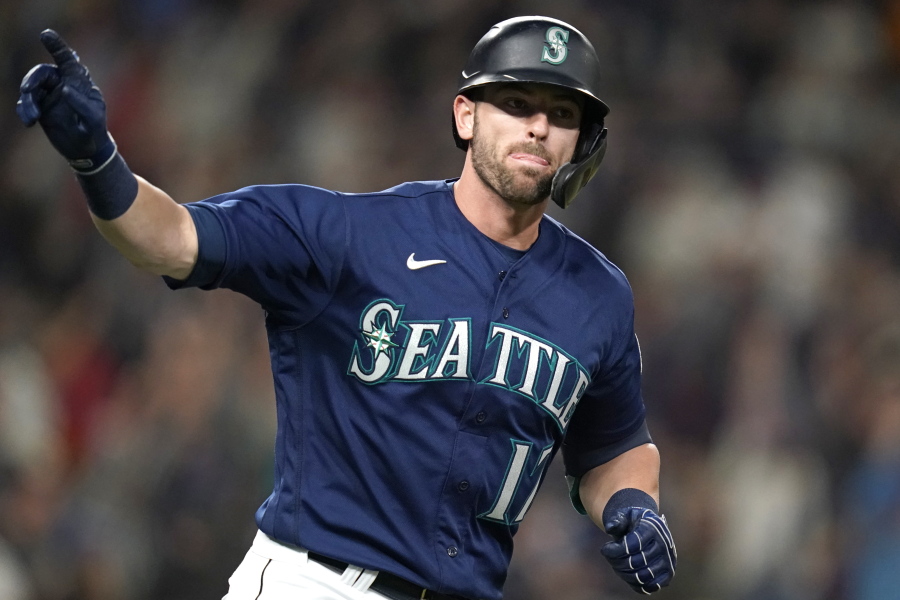Seattle Mariners' Mitch Haniger motions toward his dugout as he begins to round the bases on his two-run home run against the Los Angeles Angels in the fifth inning of a baseball game Saturday, Oct. 2, 2021, in Seattle.