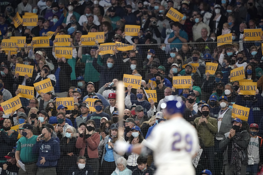 Seattle Mariners fans hold "Believe" signs as Seattle Mariners' Cal Raleigh bats against the Los Angeles Angels on Sunday in Seattle. (Ted S.