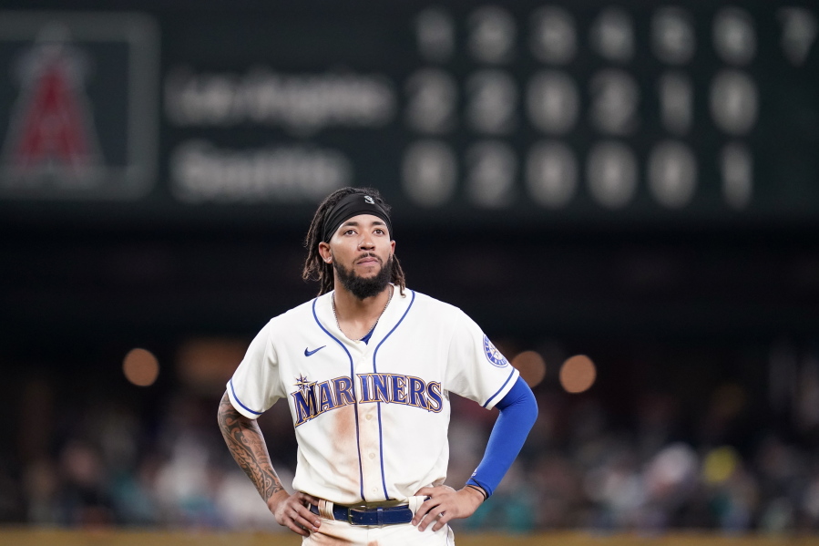 Seattle Mariners' J.P. Crawford stands on the field after being thrown out on a fielder's choice by the Los Angeles Angels to end the sixth inning of a baseball game Sunday, Oct. 3, 2021, in Seattle.