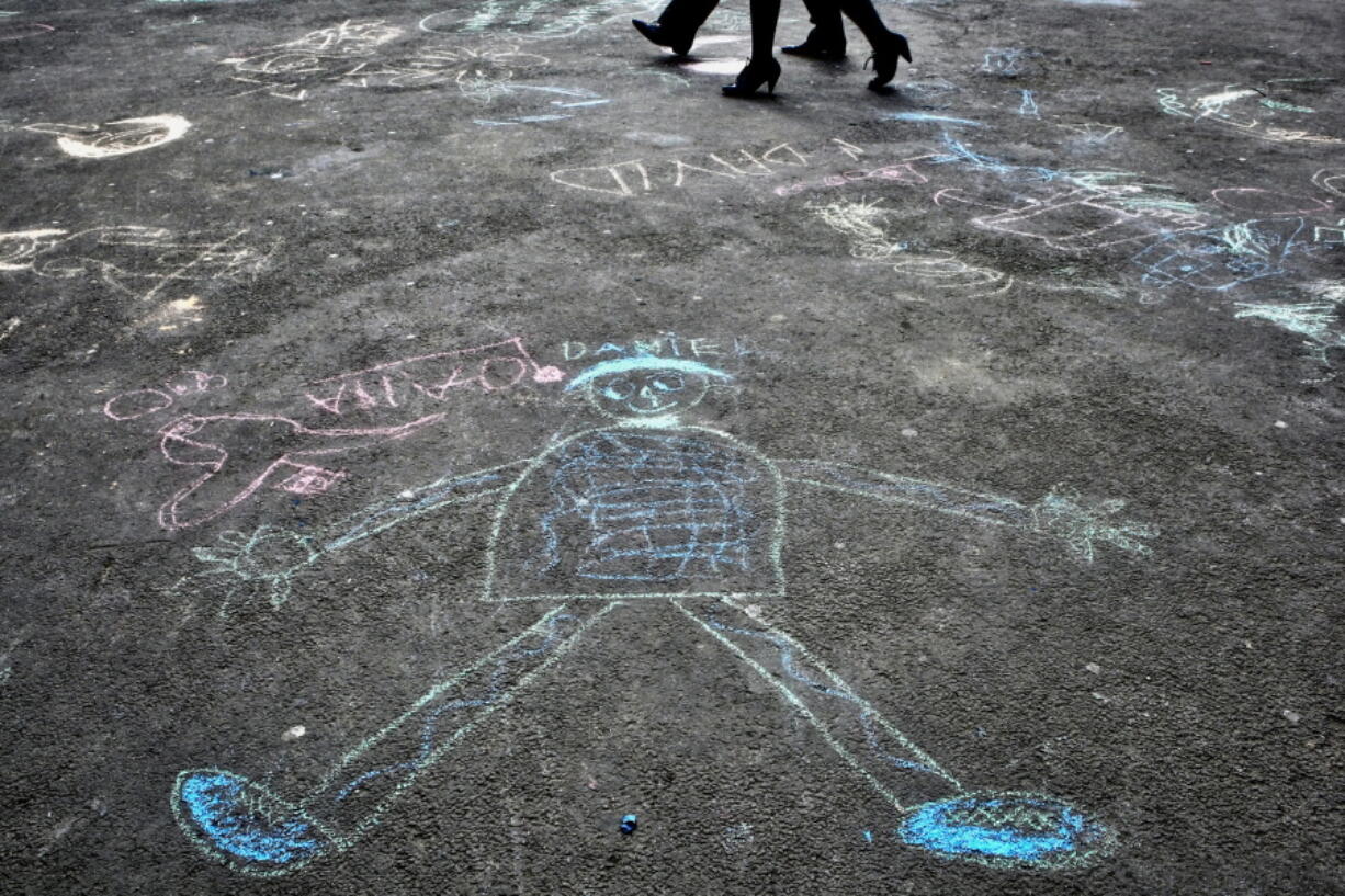Pedestrians walk past drawings by autistic children after an event in Bucharest, Romania, to mark World Autism Awareness Day in 2011.