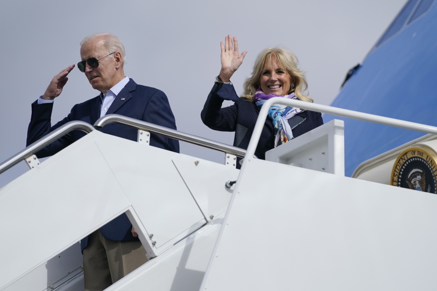 President Joe Biden returns a salute as he and first lady Jill Biden board Air Force One for a trip to Rome to attend the G-20 meeting, Thursday, Oct. 28, 2021, in Andrews Air Force Base, Md.