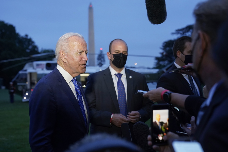 President Joe Biden talks with reporters after returning to the White House in Washington, Tuesday, Oct. 5, 2021, after a trip to Michigan to promote his infrastructure plan.
