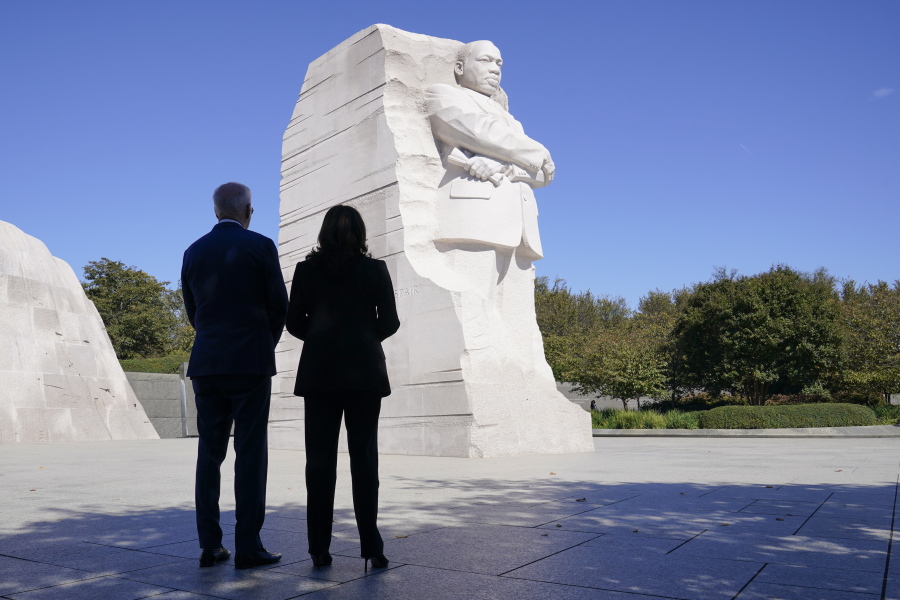 President Joe Biden and Vice President Kamala Harris stand together at the Martin Luther King, Jr. Memorial as they arrive to attend an event marking the 10th anniversary of the dedication of memorial in Washington, Thursday, Oct. 21, 2021.