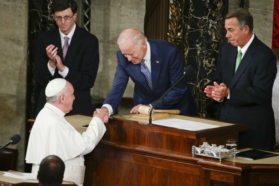 FILE - In this Sept. 24, 2015, file photo Vice President Joe Biden shakes hands with Pope Francis on Capitol Hill in Washington, prior to the pope's address to a joint meeting of Congress, making history as the first pontiff to do so. House Speaker John Boehner of Ohio is at right. Biden is scheduled to meet with Pope Francis this coming Friday at the Vatican.