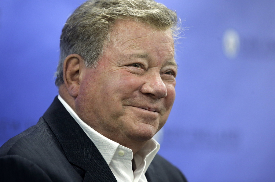 FILE - In this May 6, 2018 file photo, actor William Shatner takes questions from reporters after delivering the commencement address at New England Institute of Technology graduation ceremonies, in Providence, R.I. Star Trek's Captain Kirk is rocketing into space this month -- boldly going where no other sci-fi actors have gone. Jeff Bezos' space travel company, Blue Origin, announced Monday, Oct. 4, 2021 that Shatner will blast off from West Texas on Oct. 12.
