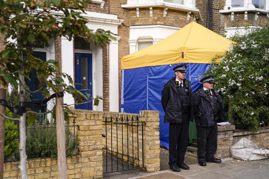 FILE - In this Sunday, Oct. 17, 2021 file photo, police officers stand outside a house in north London, thought to be in relation to the death of member of Parliament David Amess. The killing of British lawmaker Amess is once again fueling concern about a government program that tries to prevent at-risk young people from becoming radicalized, with critics saying the strategy is falling short and unfairly targets Muslim communities.