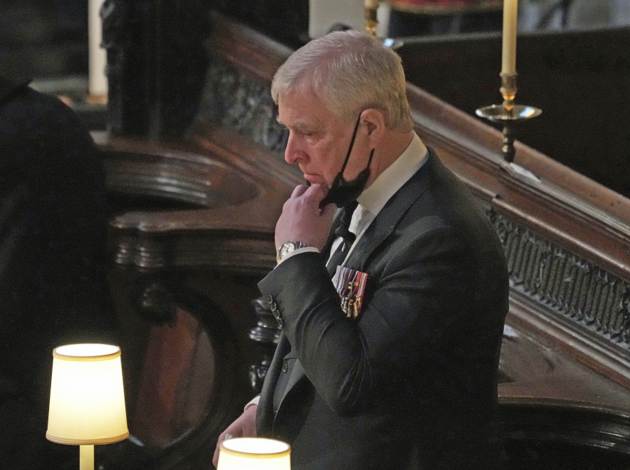FILE - Britain's Prince Andrew stands inside St. George's Chapel during the funeral of his father, Prince Philip, at Windsor Castle, Windsor, England, Saturday April 17, 2021. British police said Sunday, Oct. 10, 2021 that they will not be taking any further action against Prince Andrew after a review prompted by a Jeffrey Epstein accuser who claims that he sexually assaulted her.