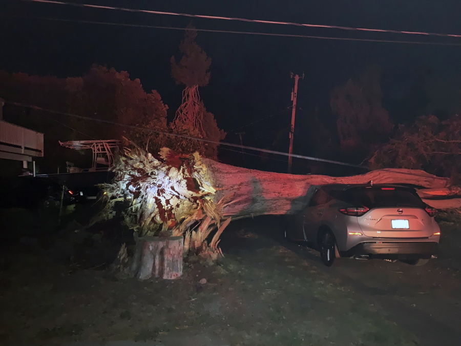 This early Monday, Oct. 11, 2021, photo provided by CalFire shows one of several vehicles damaged during a wind event in El Granada village in the coastal area of northern San Mateo County, Calif.