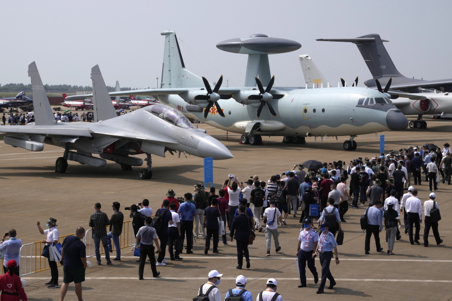 Visitors view the Chinese military's J-16D electronic warfare airplane, left, and the KJ-500 airborne early warning and control aircraft at right during 13th China International Aviation and Aerospace Exhibition, also known as Airshow China 2021, Wednesday, Sept. 29, 2021, in Zhuhai in southern China's Guangdong province. With record numbers of military flights near Taiwan over the last week, China has been stepping up its harassment of the island it claims as its own, showing an new intensity and sophistication as it asserts its territorial claims in the region.