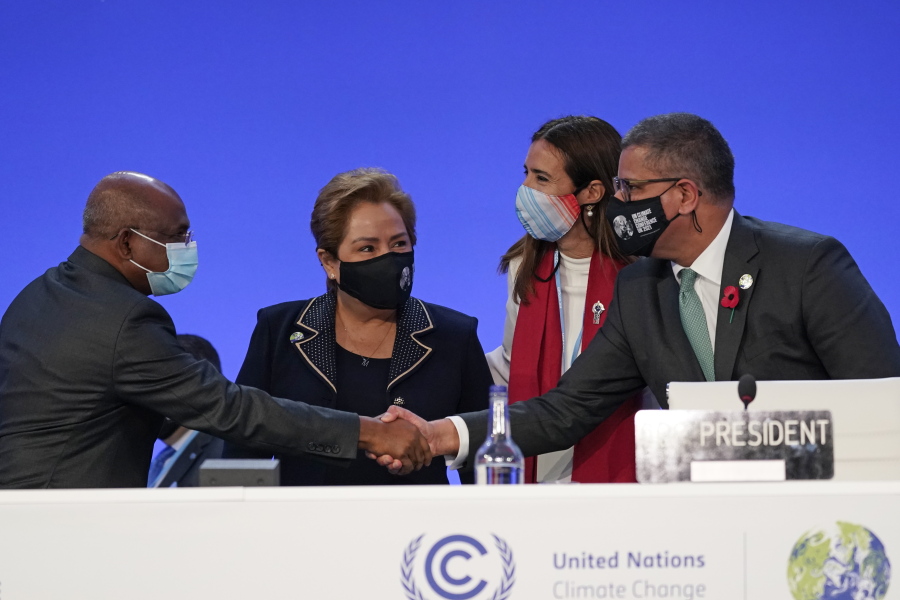Alok Sharma, right, President of the COP26 summit shakes hands with UNGA President Abdulla Shahid as outgoing COP president Carolina Schmidt, second right, and Patricia Espinosa, UNFCCC Executive-Secretary look on during the Procedural Opening of the COP26 U.N. Climate Summit in Glasgow, Scotland, Sunday, Oct. 31, 2021. The U.N. climate summit in Glasgow formally opens Sunday, a day before leaders from around the world gather in Scotland's biggest city to lay out their vision for addressing the common challenge of global warming.