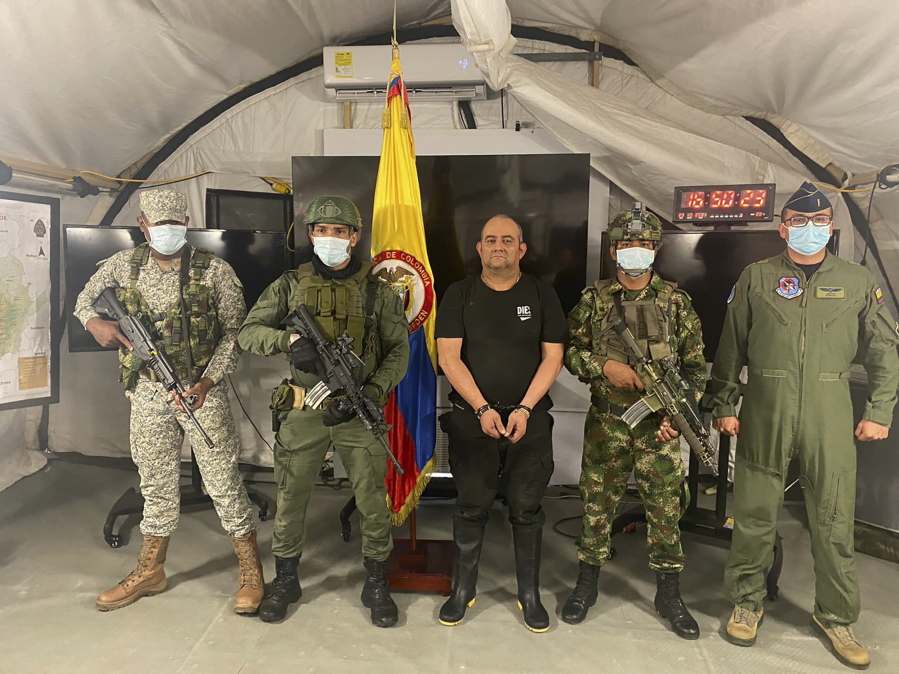 In this photo released by the Colombian presidential press office, one of the country's most wanted drug traffickers, Dairo Antonio Usuga, alias "Otoniel," leader of the violent Clan del Golfo cartel, is presented to the media at a military base in Necocli, Colombia, Saturday, Oct. 23, 2021.