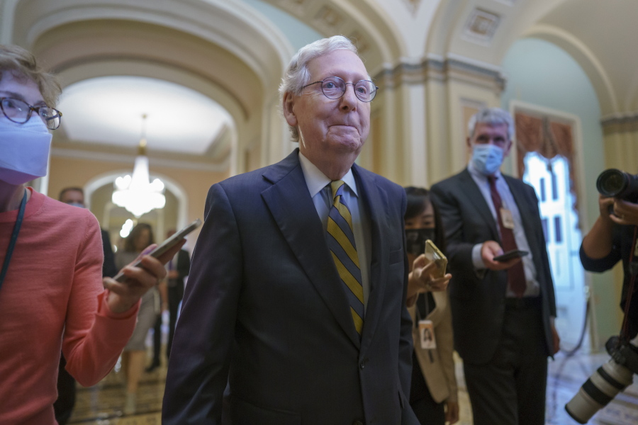 Senate Minority Leader Mitch McConnell, R-Ky., is surrounded by journalists as he walks to the Senate Chamber for a vote as Democrats look for a way to lift the debt limit without Republican votes, at the Capitol in Washington, Wednesday, Oct. 6, 2021. (AP Photo/J.