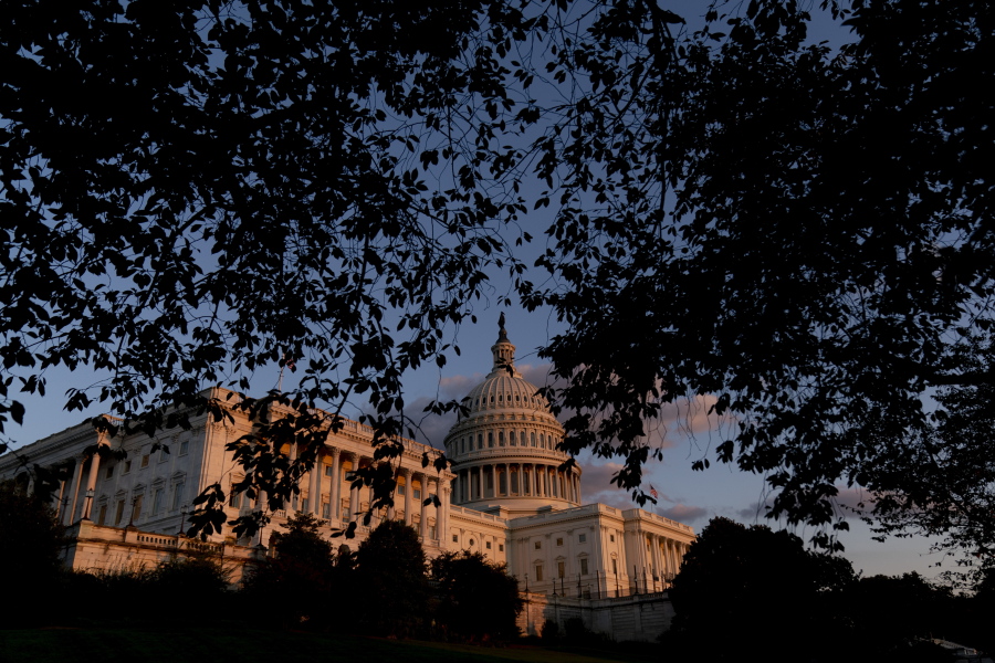 FILE - The U.S Capitol at sunset in Washington, on Sept. 30, 2021. Year-end pileups of crucial legislation and the brinkmanship that goes with it are annual rituals for Congress. But this time, testy lawmakers are barreling toward an autumn of battles that are striking for the risks they pose to both parties and their leaders. Miscalculate and there could be a calamitous federal default, a collapse of Biden's domestic agenda and, for good measure, a damaging government shutdown.