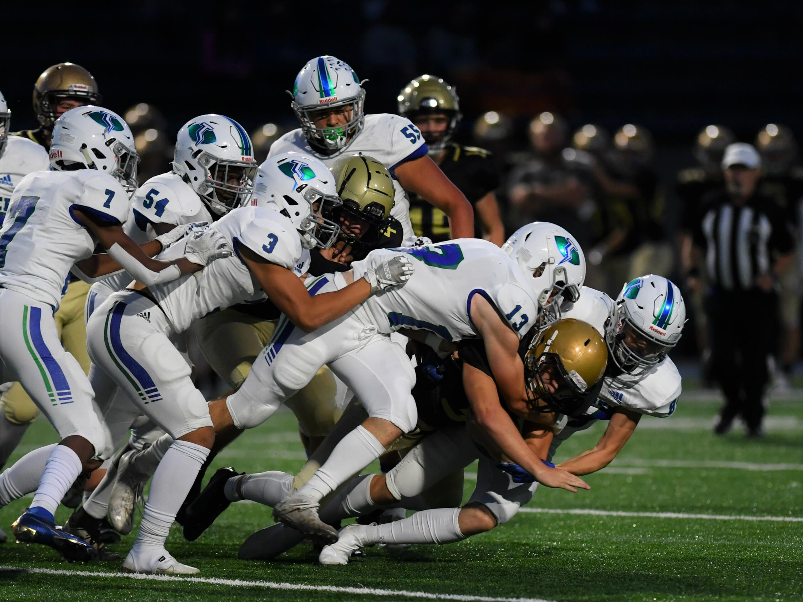 A host of Mountain View defenders combine to take down Kelso tailback Conner Noah in the first quarter of MV’s 20-17 win over the Hilanders at Schroeder Field on Oct.
