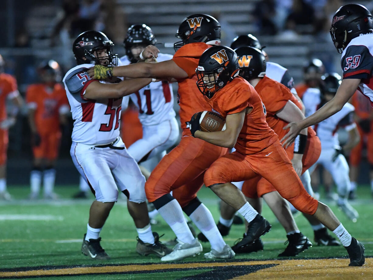 Washougal’s Will Cooper gains yards against R.A. Long on Friday.