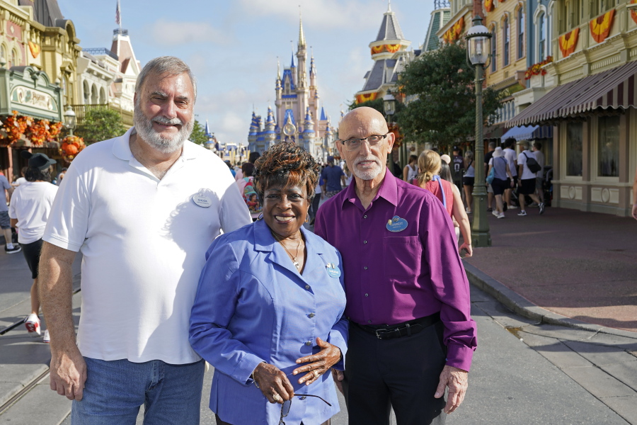 Walt Disney World employees from left, Chuck Milam, Earliene Anderson and Forrest Bahruth gather at the Magic Kingdom on Aug. 30 in Lake Buena Vista, Fla. to celebrate their 50 years working at the park.