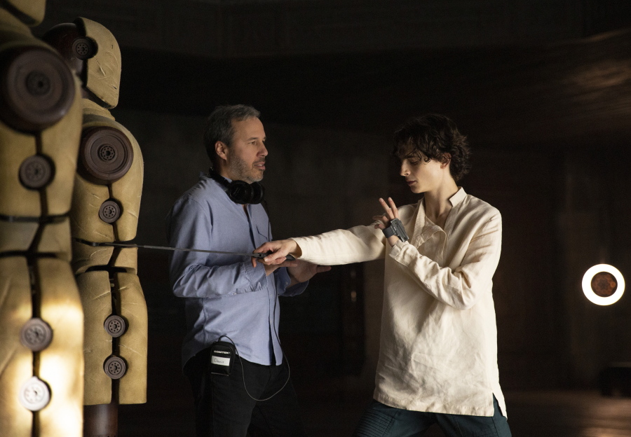 This image released by Warner Bros. Pictures shows director Denis Villeneuve, left, with actor Timothee Chalamet on the set of "Dune." (Chia Bella James/Warner Bros. Pictures via AP) (Warner Bros.