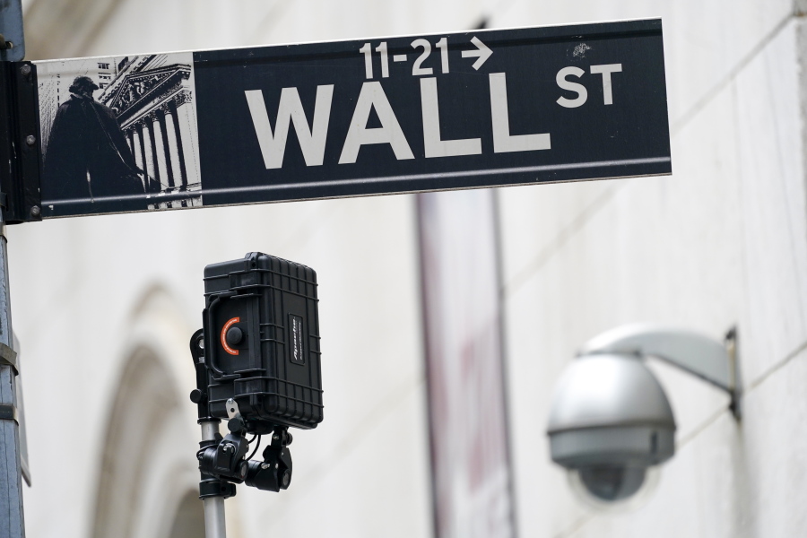 FILE - A Wall Street sign is seen next to surveillance equipment outside the New York Stock Exchange, Tuesday, Oct. 5, 2021, in New York.  Stocks are edging higher in early trading on Wall Street Tuesday, Oct. 12,  as traders wait for more data on inflation and corporate earnings this week.