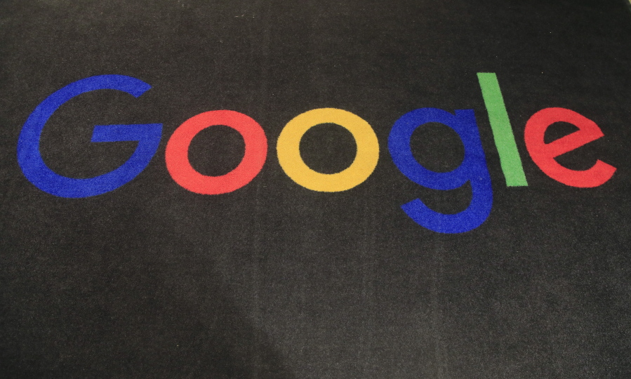 FILE - In this Nov. 18, 2019 file photo, the logo of Google is displayed on a carpet at the entrance hall of Google France in Paris. A new search feature rolled out Wednesday, Oct. 6, 2021 tells users which flights have lower carbon emissions, giving them the ability to choose flights based on carbon emissions just as they would price or the number of layovers.