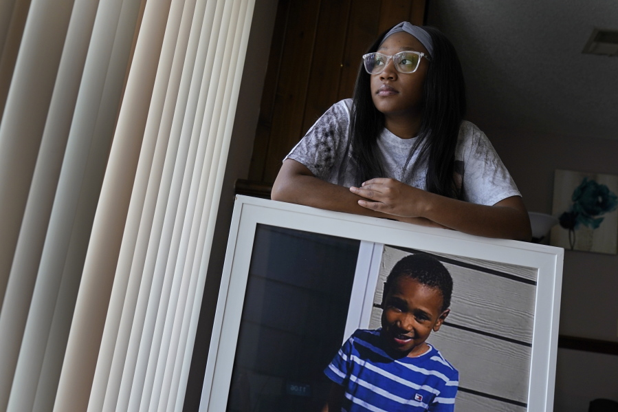 Charron Powell stands with a photo of her son, LeGend Talieferro, at her home in Raytown, Mo. on Sunday, Oct. 3, 2021. LeGend was 4 years old when he was fatally shot June 29, 2020 while he was sleeping in an apartment staying with his father.