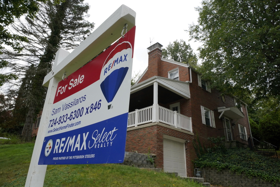 FILE - A for sale sign is displayed outside a home in Mount Lebanon, Pa., on Tuesday, Sept. 21, 2021. U.S. home prices jumped in August by a near-record amount from a year earlier, as Americans eager to buy a home drove up prices on a dwindling number of properties. (AP Photo/Gene J.