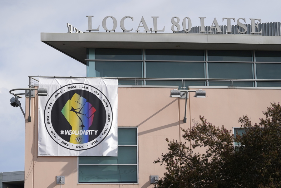 A poster advocating union solidarity hangs from the office building housing The International Alliance of Theatrical Stage Employees Local 80, Monday, Oct. 4, 2021, in Burbank, Calif. The IATSE overwhelmingly voted to authorize a strike for the first time in its 128-year history.