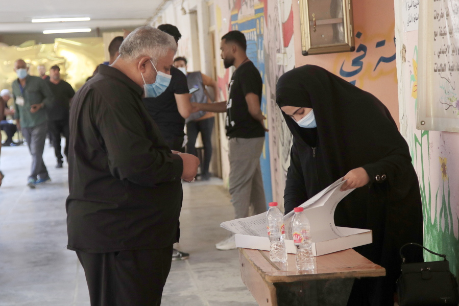 Iraqis voters gather to cast their vote at a ballot station in the country's parliamentary elections in Baghdad, Iraq, Sunday, Oct. 10, 2021. Iraq closed its airspace and land border crossings on Sunday as voters headed to the polls to elect a parliament that many hope will deliver much needed reforms after decades of conflict and mismanagement..