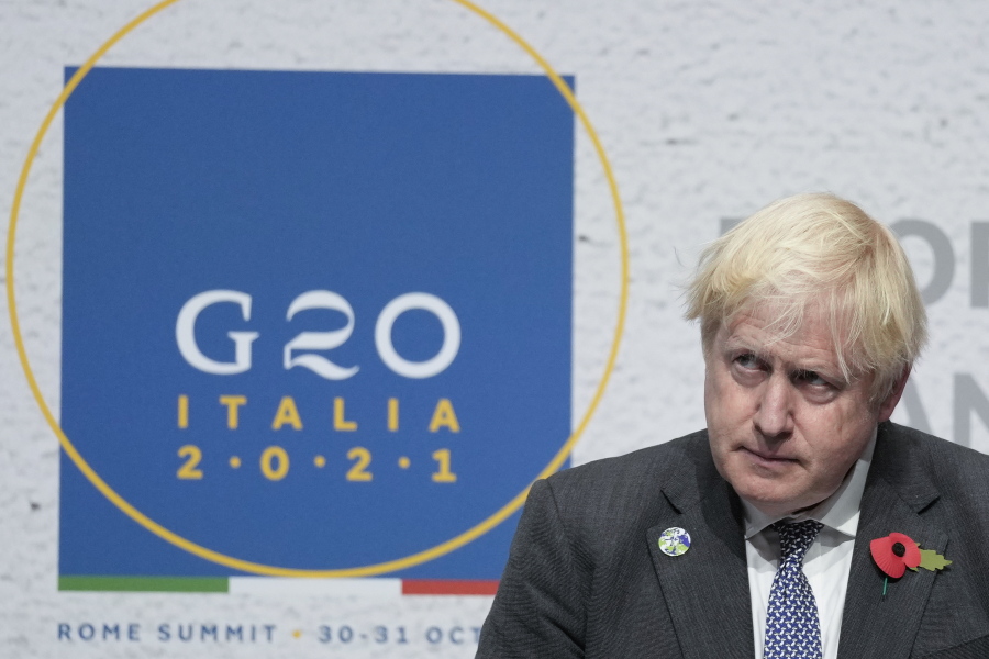 British Prime Minister Boris Johnson listens to a question during a press conference at the La Nuvola conference center for the G20 summit in Rome, Sunday, Oct. 31, 2021. Leaders of the world's biggest economies made a compromise commitment Sunday to reach carbon neutrality "by or around mid-century" as they wrapped up a two-day summit that was laying the groundwork for the U.N. climate conference in Glasgow, Scotland.