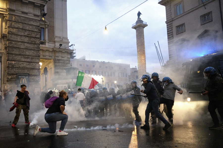 FILE - In this Saturday, Oct. 9, 2021 file photo, demonstrators and police clash during a protest, in Rome. An extreme-right political party's violent exploitation of anger over government anti-pandemic restrictions is forcing Italy to wrestle with its fascist legacy and fueling fears that there could be a replay of last week's mobs trying to force their way toward Parliament.