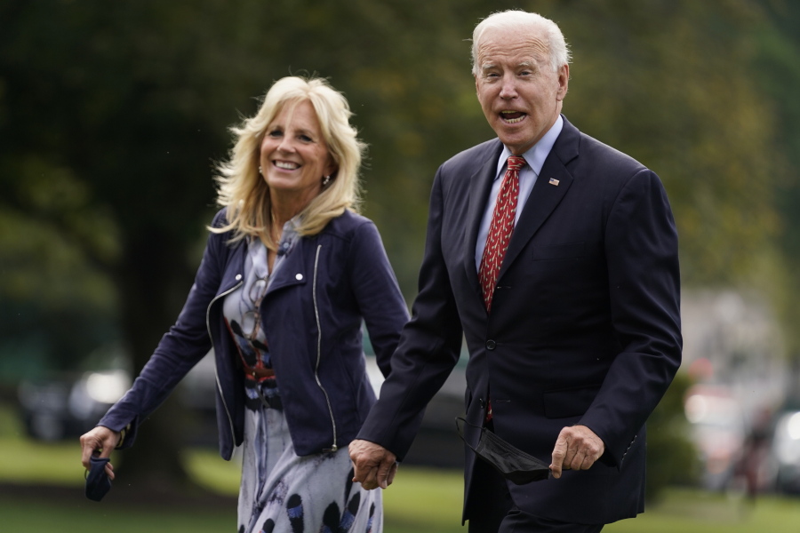 In this Oct. 4, 2021, photo, President Joe Biden and first lady Jill Biden arrive on the South Lawn of the White House after spending the weekend in Wilmington, Del., in Washington.
