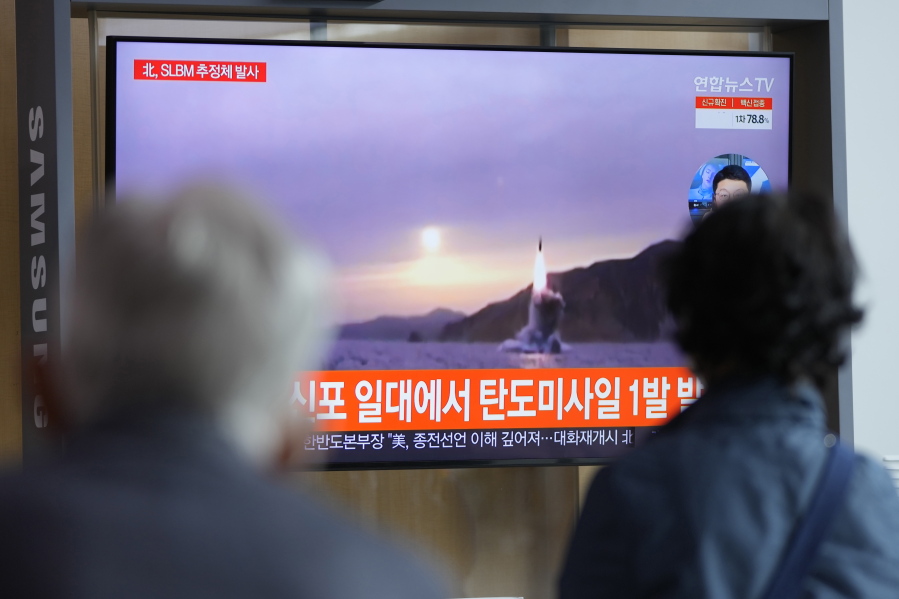 People watch a TV screen showing a news program reporting about North Korea's missile launch with file footage at a train station in Seoul, South Korea, Tuesday, Oct. 19, 2021. North Korea fired a ballistic missile into the sea on Tuesday in a continuation of its recent weapons tests, the South Korean and Japanese militaries said, hours after the U.S. reaffirmed its offer to resume diplomacy on the North's nuclear weapons program.