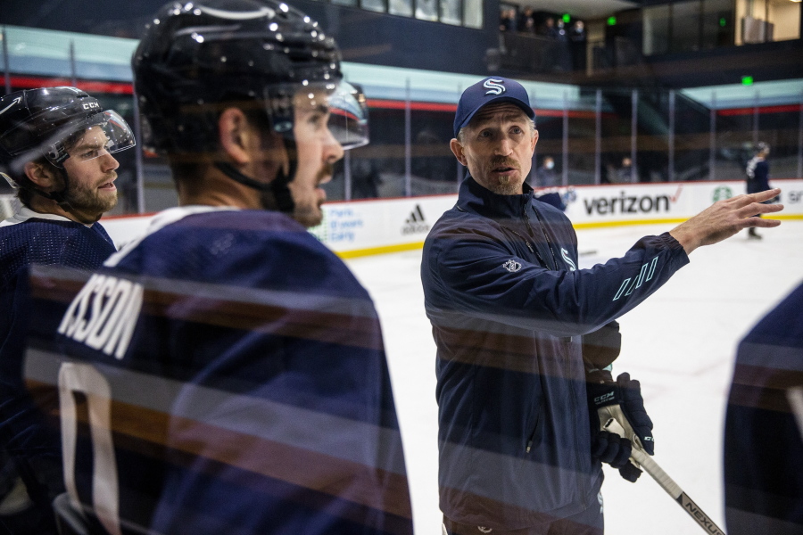 Seattle Kraken head coach Dave Hakstol discusses a drill with players during training camp at Kraken Community Iceplex last month in Seattle.