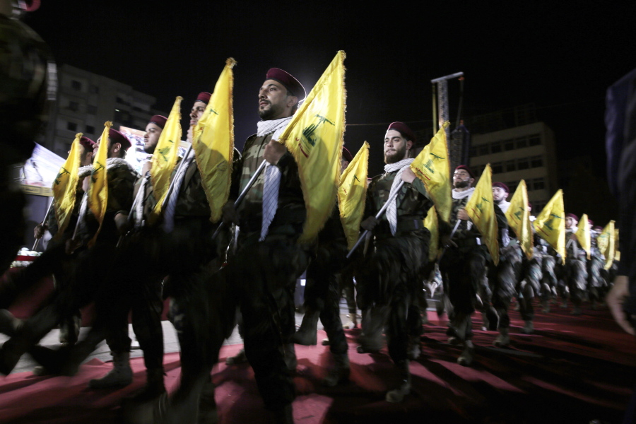 FILE - In this May 31, 2019 file photo, Hezbollah fighters march at a rally to mark Jerusalem day or Al-Quds day, in the southern Beirut suburb of Dahiyeh, Lebanon. On Monday, Oct. 18, 2021, Hezbollah leader Sheik Hassan Nasrallah revealed that his militant group has 100,000 trained fighters.