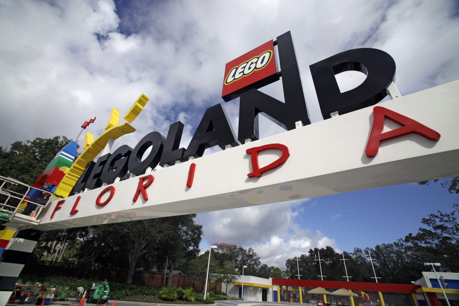 FILE - In this Tuesday, Sept. 27, 2011, file photo, a worker puts finishing touches on the entrance sign at Legoland Florida in Winter Haven, Fla. The Legoland theme park in Florida is planning an expansion next year including new rides, according to plans filed with the city nearest the attraction.
