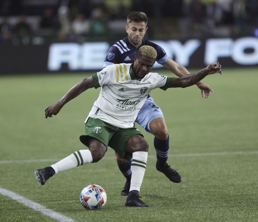 Portland Timbers forward Dairon Asprilla, right, controls the ball against Vancouver Whitecaps defender Marcus Godinho, left, during the first half of an MLS soccer match in Portland, Ore., Wednesday, Oct. 20, 2021.